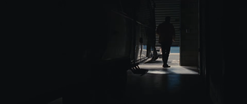 A man closing a self storage unit door from the insude.